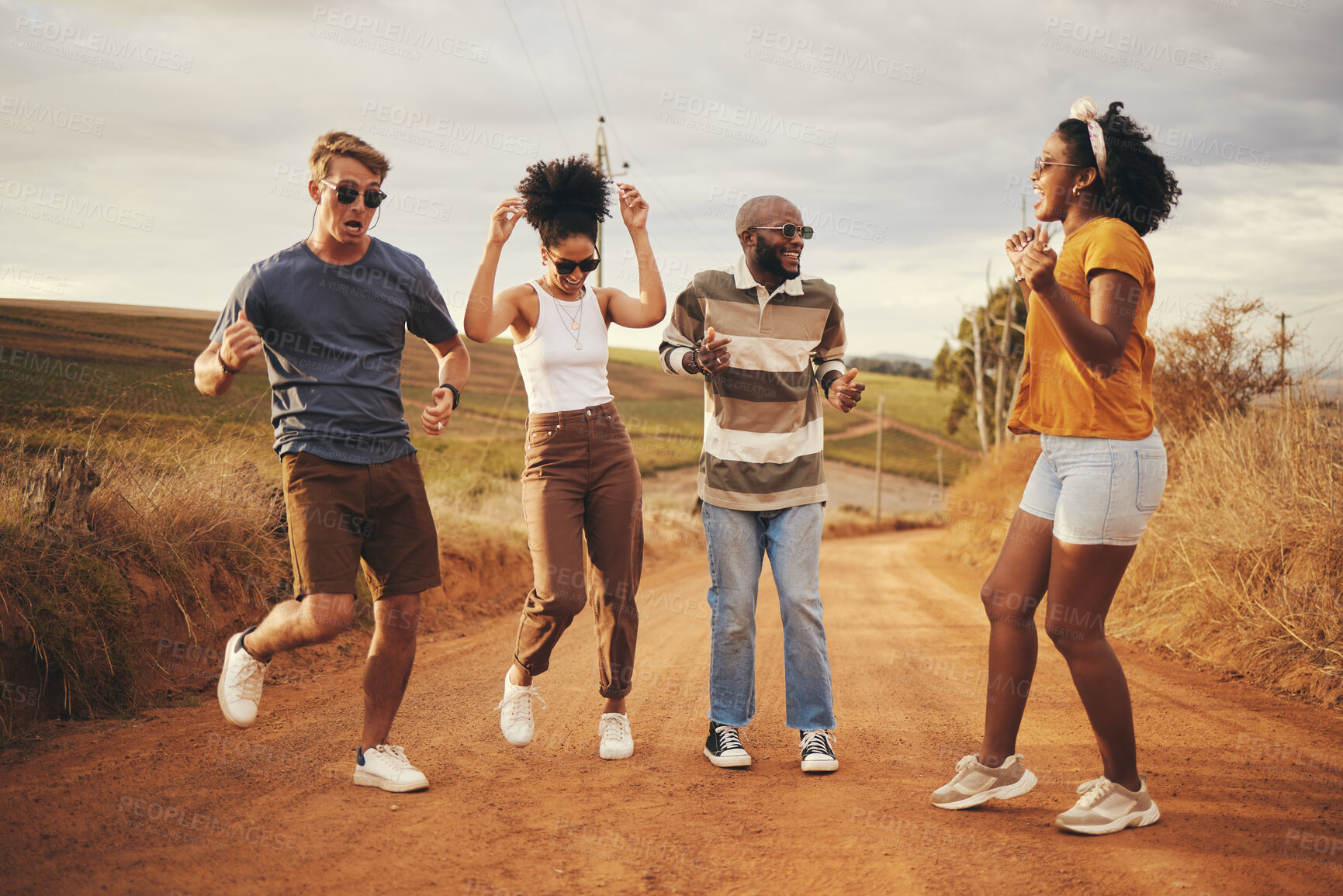 Buy stock photo Friends dance, travel and freedom adventure on a nature dirt road jump for fun and joy outdoor. Diversity of people and travelers happy about free and summer holiday laughing together in desert