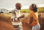 Conversation, couple and road trip travel on a dirt road feeling happy about vacation freedom. Communication and laughing of a girlfriend and boyfriend with happiness talking about a holiday together