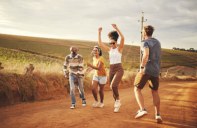 Buy stock photo Friends, nature and dance with a man and woman group outdoor in a desert on a sand road with freedom. Travel, summer or vacation with young people enjoying a holiday together and laughing or joking