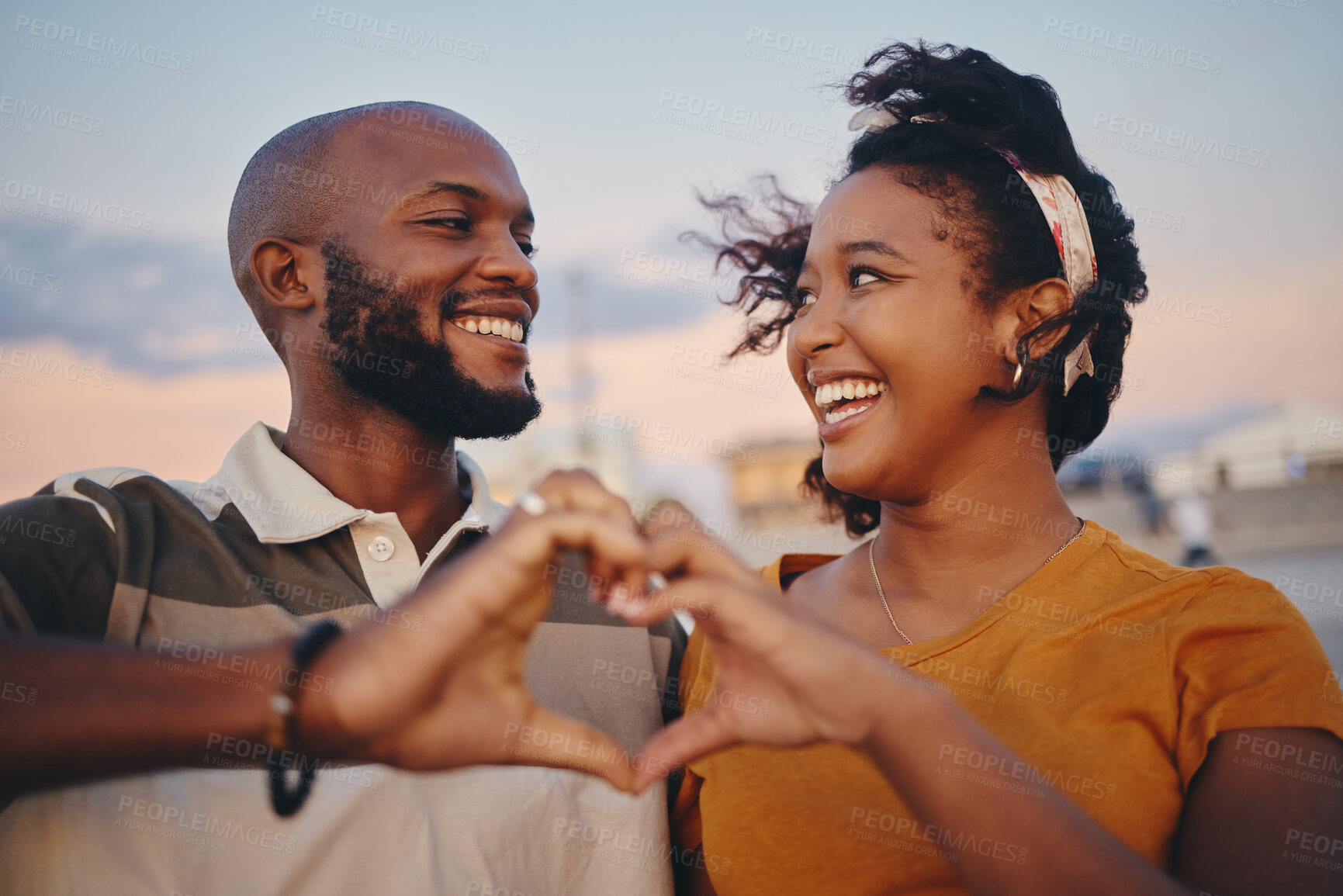 Buy stock photo Black couple, heart hand and celebrate relationship being happy, smile and romantic outdoor together. Love, man and woman smile, relax and on holiday and vacation for bonding, anniversary or romance.