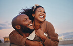 Happy black couple, love and hug laughing in joyful happiness for bonding time together in the outdoors. African American man and woman enjoying playful fun with smile for holiday break in nature