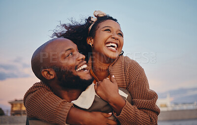 Buy stock photo Happy black couple, love and hug laughing in joyful happiness for bonding time together in the outdoors. African American man and woman enjoying playful fun piggyback with smile for holiday in nature
