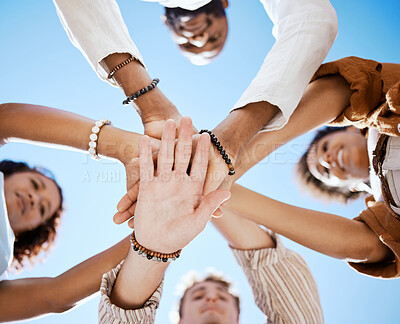 Buy stock photo Friends, trust and support hands low angle for solidarity in multicultural group with blue sky. Care, respect and love in friendship with young people who enjoy happy emotional bond together.
