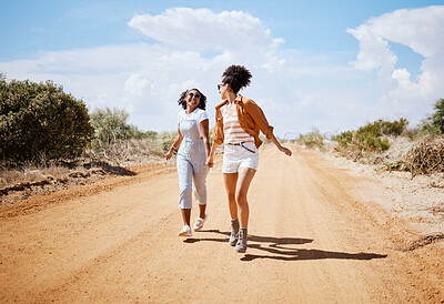 Buy stock photo Energy, friends and travel with women walking on a dirt road, explore nature and freedom. Adventure, vacation and black women having fun and bonding in Mexico, carefree and cheerful and enjoying trip