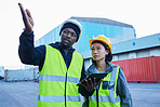 Logistics, black man and Asian woman with tablet, shipping and conversation for container planning, cargo and supply chain delivery at shipyard. Employees, strategy 
 and discuss import and export. 