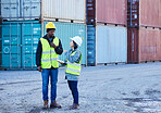 Shipping, logistics and supply chain with a man and woman courier talking in a container port for distribution. Cargo, freight and service delivery with team at work in the stock and export industry