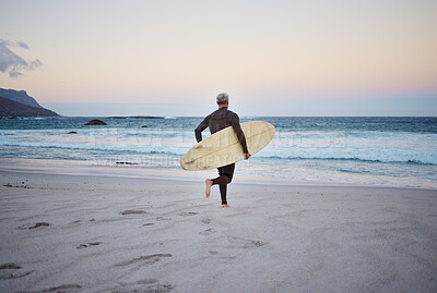 Buy stock photo Surf at the beach, man and running to ocean with surfboard for the waves, fitness and adventure. Mature surfer at sunrise, in wet suit and to enjoy the sea, travel and summer on an island. 