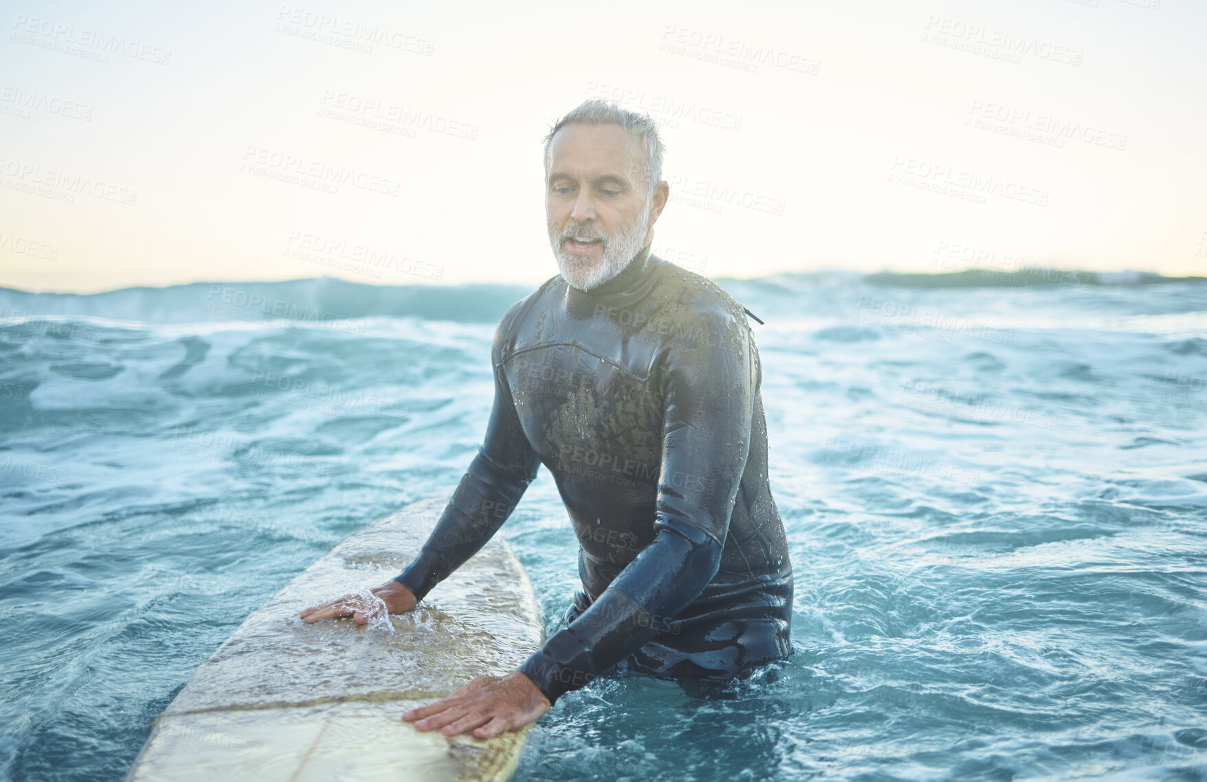 Buy stock photo Surfing, ocean and senior man swimming with board in sea blue waves and morning sky mockup. Sports, fitness and adventure surfer in tropical water for vacation, summer holiday or wellness lifestyle 