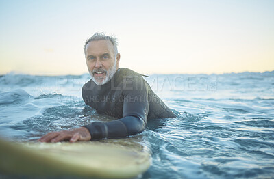 Buy stock photo Senior man, surfing in the ocean of Indonesia and free to travel the world in retirement life. Retired surfer, swimming in the sea for fitness and exercise looking to catch a perfect wave on holiday 