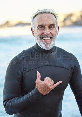 Buy stock photo Elderly, surfer and beach with hand sign for portrait with smile in summer by ocean for wellness, fitness and health. Senior, man and surf by sea in retirement on vacation, holiday or travel to Miami