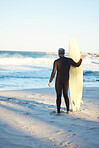 Beach, board and man surfing on holiday for travel and adventure by the water in Hawaii. Back of surfer by the ocean for the waves and freedom of summer on sea vacation on an island in nature