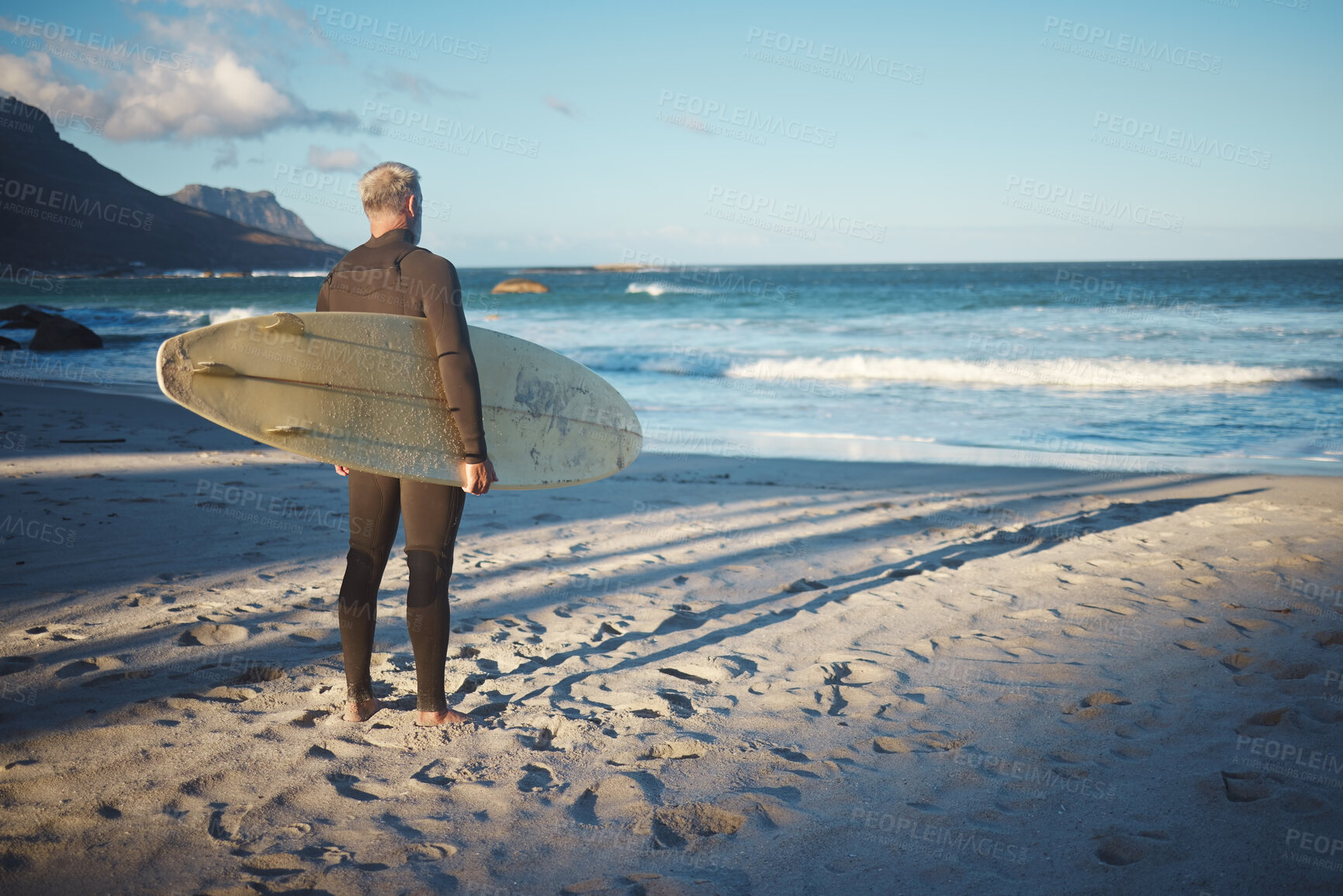 Buy stock photo Surfer, elderly and beach for wellness, fitness and health to surf on adventure in summer. Senior, man and sea in morning with waves by ocean to relax, workout and exercise in water in Australia