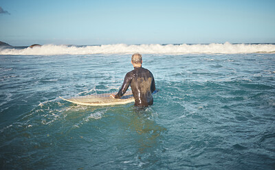Buy stock photo Surfer and man in water watching wave for high tide while holding surfboard at sunny USA beach. Retirement person enjoying surfing sport leisure in California waiting for ocean level to rise.