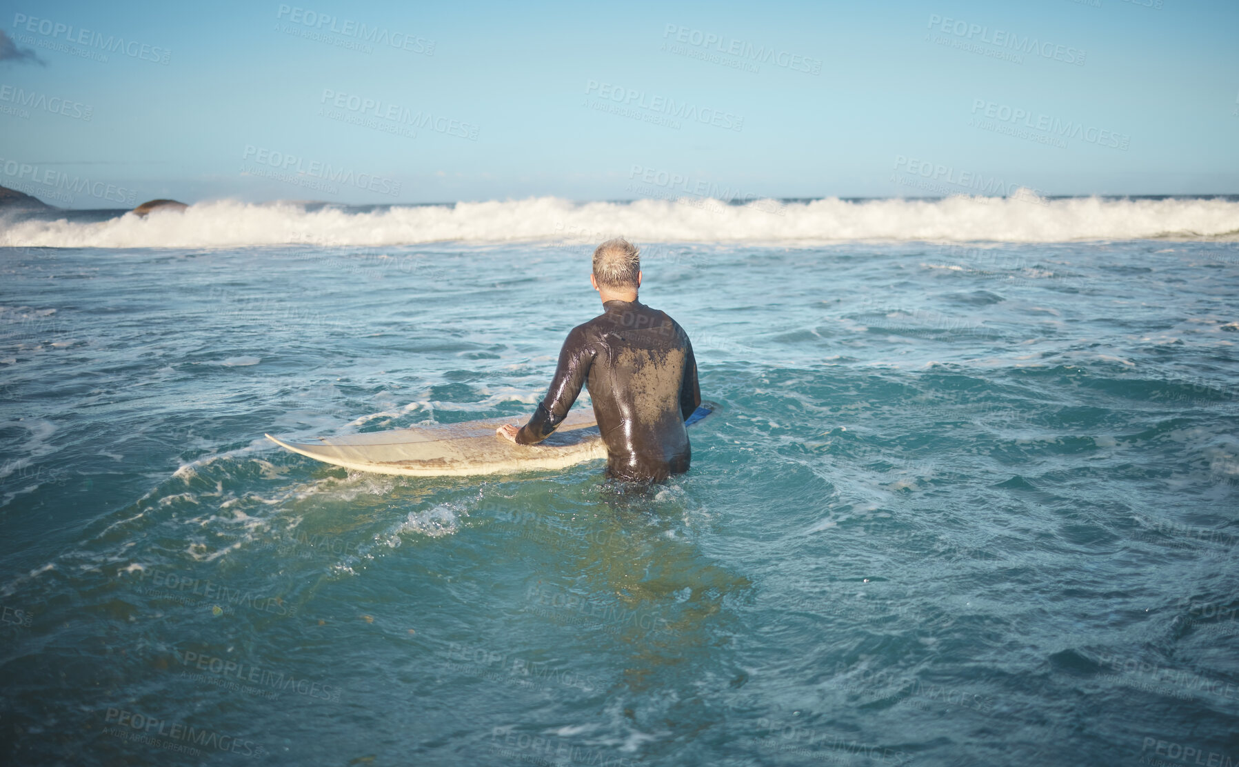 Buy stock photo Surfer and man in water watching wave for high tide while holding surfboard at sunny USA beach. Retirement person enjoying surfing sport leisure in California waiting for ocean level to rise.