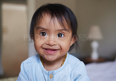 Buy stock photo Happy, portrait smile and Down syndrome baby relaxing on a bed in happiness at home. Cheerful little child with genetic disorder or disability smiling in bedroom for cute childhood and development