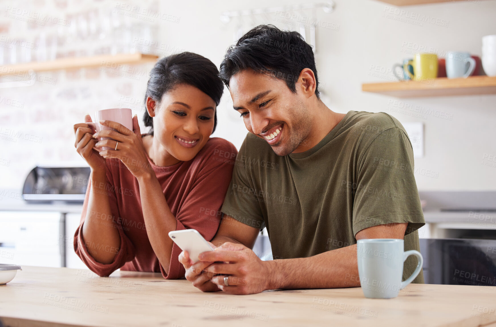 Buy stock photo Phone, social media and couple with a man and woman in the kitchen of their home together in the morning. Mobile, coffee and communicaton with a married male and female reading a text in their house