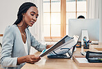 Black woman, office and book at desk reading with laptop for research, education or learning at work. Woman, training and paper with computer for development, growth and study at business in Paris