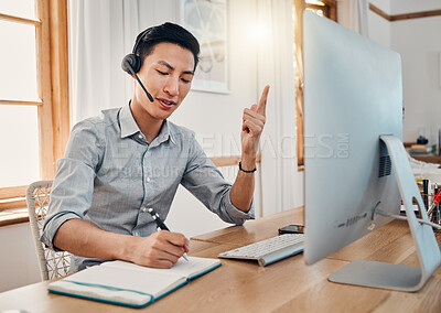 Buy stock photo Customer support, telemarketing and writing with a man consultant doing remote work from his home office. Consulting, notebook and retail with an asian virtual assistant at work on a computer