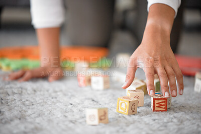 Buy stock photo Hands, cleaning and toys with a woman or mother picking up building blocks in the house to clean or tidy. Hand, responsible and object with a female cleaner working on a home floor for housework
