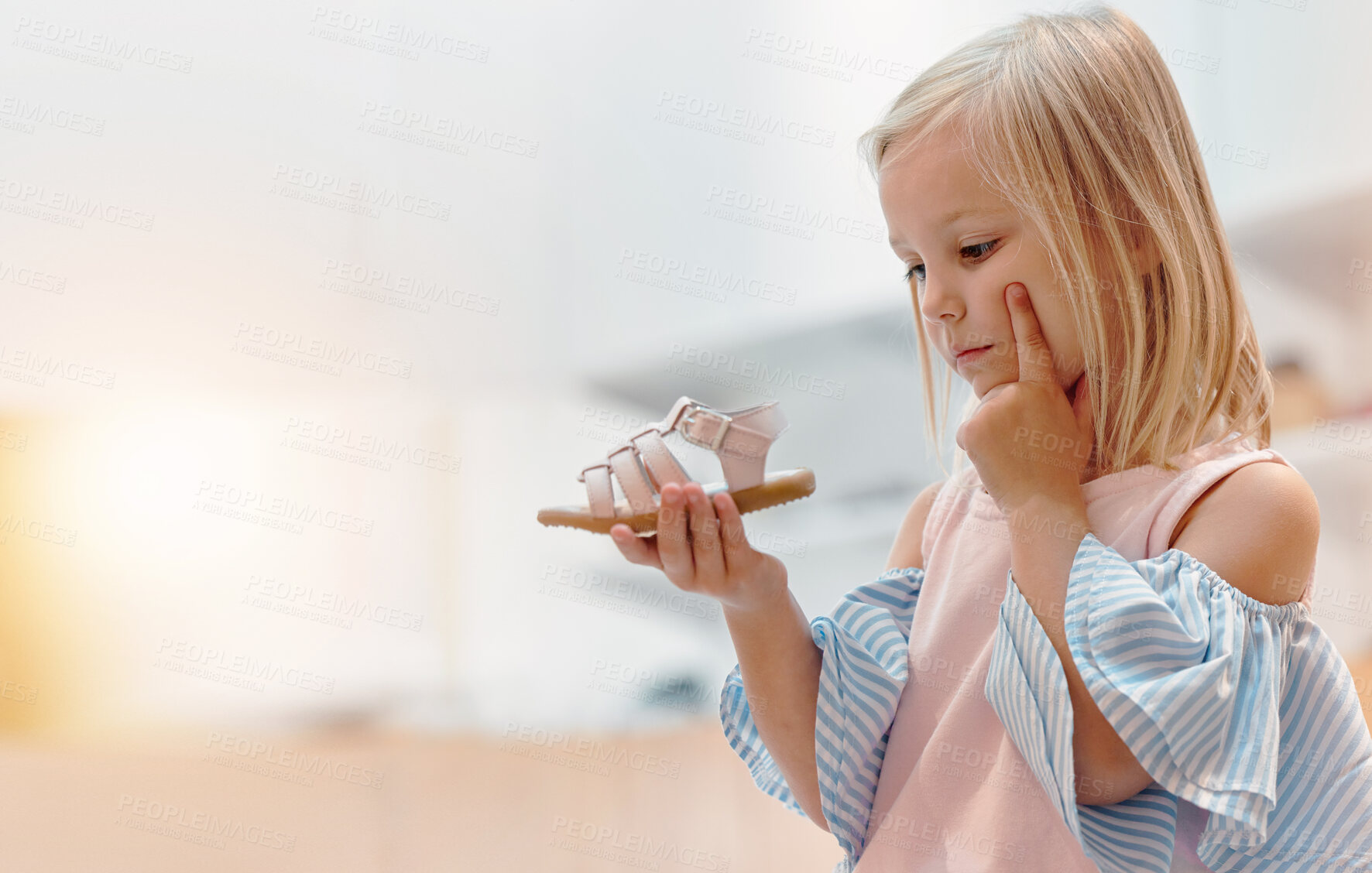 Buy stock photo Children, shoes and fashion with a girl thinking about a choice in a retail store or mall while shopping. Kids, idea and customer with a female child deciding on a footwear purchase with mockup