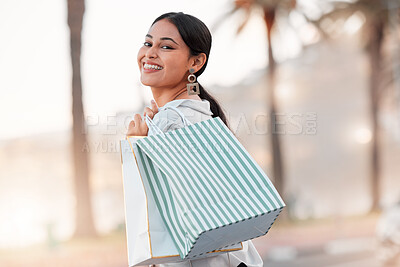 Buy stock photo Woman portrait, retail shopping bag and city travel for discount sales, market deals and promotion in Dubai. Happy rich arab customer, consumer and wealthy person buying luxury fashion street outdoor