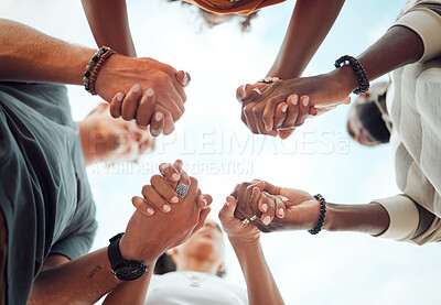 Buy stock photo Holding hands, support and friends praying for spiritual growth, community and gratitude together with sky from below. Group of people in partnership for hope, love and human faith in connection 