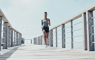 Buy stock photo Fitness, exercise and running with black woman on bridge with morning workout for sports, health and wellness. Motivation, freedom and energy with runner training for marathon, goals and vision 