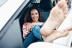 Portrait of woman with feet out window of car, sitting in passenger seat with smile on face. Travel, freedom and weekend holiday on the road for adventure. Young girl, barefoot and happy on roadtrip