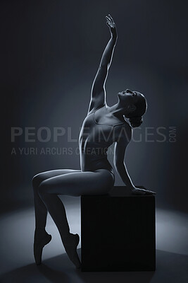 Buy stock photo Ballet, art and dance with a woman ballerina in studio on a dark background for a theatre or stage performance. Creative, artistic and monochrome with a young female dancer in rehearsal for a show
