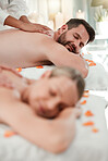 Couple, relax and luxury spa massage enjoying peaceful relaxation or pamper session together at holiday resort. Man and woman in relationship relaxing in calming health and zen treatment on vacation