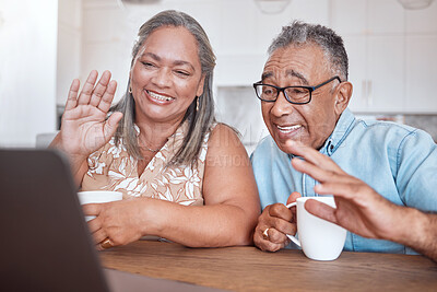 Buy stock photo Laptop, video call and senior couple wave at friends and family while drinking coffee together at a table. Lockdown, communication and elderly man and woman enjoy online conversation in their home