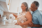 Tea, couple and retirement with a man and woman using a kettle in the kitchen of their home together. Love, morning and romance with a senior male and woman making a coffee beverage in their house