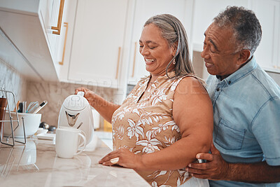 Buy stock photo Tea, couple and retirement with a man and woman using a kettle in the kitchen of their home together. Love, morning and romance with a senior male and woman making a coffee beverage in their house