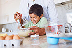 Baking, kid and father in kitchen learning to make cake, cookies or biscuits in home. Support, care and bonding with parent teaching boy how to cook, bake and cooking with eggs, wheat flour and milk

