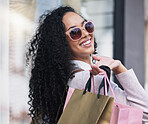 Happy, woman customer and shopping with bags, smile and leave fashion store. Retail therapy, female consumer and confident relax shopper enjoy sale, sunglasses or holding clothes purchase in boutique