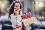 Woman, christmas shopping and phone call in the city in communication with rich lifestyle outdoor. Female with retail gift in conversation with smile and laugh on mobile smartphone in the a market