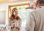 Old couple, coffee and conversation in home kitchen, drinking espresso or caffeine. Retirement, elderly man and woman talking, communication and chat while spending time together with tea in house.