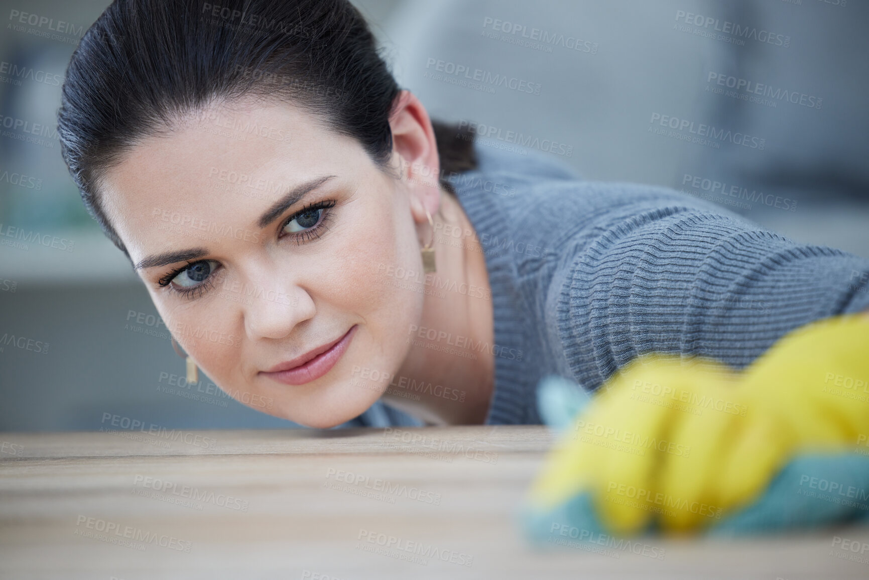 Buy stock photo Woman, focus and cleaning table in home, workplace or office for hygiene, germs or bacteria. Cleaner, precision and working on wood desk with gloves, cloth or rag in domestic service job in Warsaw