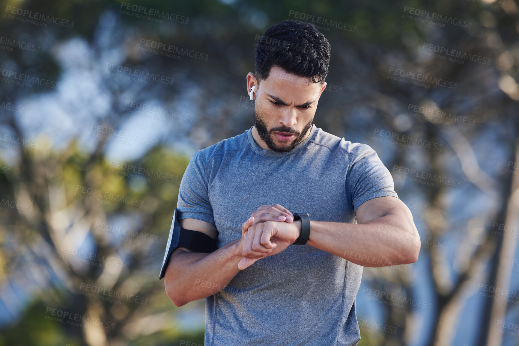 Buy stock photo Watch, monitor and man training for fitness, marathon motivation and cardio health in nature. Athlete runner check for time after run, exercise progress and reading notification after workout in park