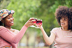 Toast, celebration and friends with wine on a picnic in a park together during summer. Happy, relax and African women with cheers and glasses of alcohol to celebrate birthday in nature garden