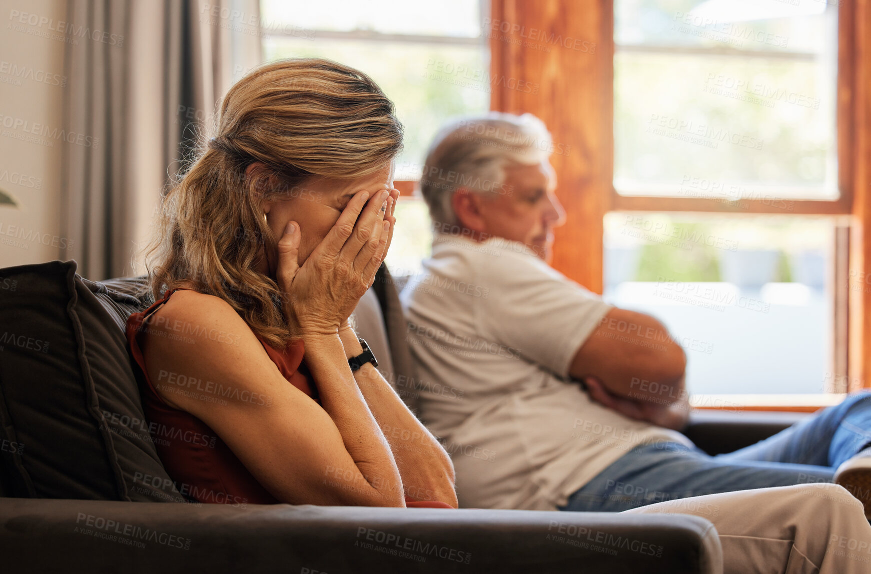 Buy stock photo Crying, divorce and fight with a senior woman sad in her home after an argument with her husband. Depression, stress and couple with a wife angry after fighting with her elderly man sitting on a sofa