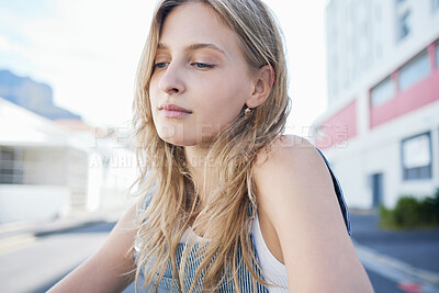 Buy stock photo Thinking girl in the street in the city, sad expression on her face. Young student sitting in road in urban town with mindful thoughts, depression and mental health. Woman alone, sadness and stress