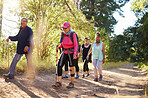 Hiking, walking and senior women in a forest or woods on a hiking trail together. Group of old women doing exercise, workout and fitness in retirement to keep active. Friends taking a walk in nature