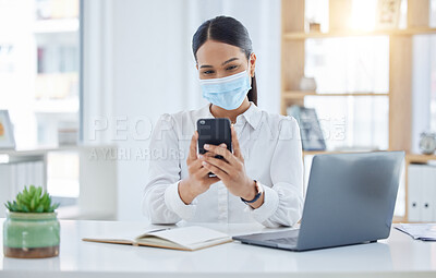 Buy stock photo Covid, mask and business woman on her phone checking her schedule, diary and health news online at the office. Employee, worker searching on social media or reading a safety policy email on internet