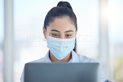 Buy stock photo Covid, business and woman reading on laptop while working in an office at work. Corporate employee with email on computer, typing proposal and doing search on the internet with face mask at a company