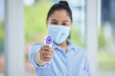 Buy stock photo Hand, woman employee and covid thermometer laser for medical exam, check or covid 19 scan at office. Healthcare worker, mask and scan for corona virus safety and wellness protection at a workplace