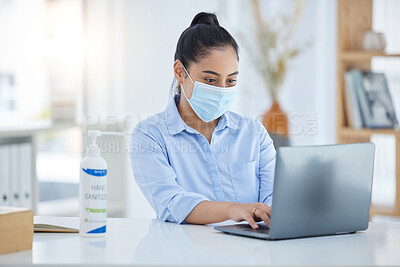 Buy stock photo Laptop, covid and corporate employee with a face mask working on a project at a desk. Professional business woman typing company schedule or email on her computer in the office during global pandemic