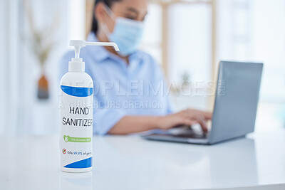 Buy stock photo Hand sanitizer, covid and business woman typing on a laptop at desk in her office with face mask. Hygiene, technology and professional employee working on project with computer during corona pandemic