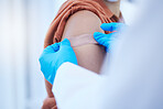 Doctor hand, covid vaccine and band aid on patient for virus protection or illness prevention. Medical professional, health care worker and place plaster on arm wound after vaccination injection