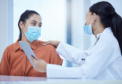 Buy stock photo Covid, face mask and doctor on tablet consulting patient for corona virus vaccine or treatment. Health, safety and medical woman talking, help or support for covid 19 checkup in hospital on tech.



